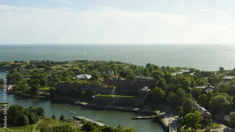 Aerial view overlooking the Susisaari island, at the Suomenlinna fortress, sunny, summer day, in Helsinki, Finland - tracking, pan, drone shot Aerial view overlooking the Susisaari island, at the Suomenlinna fortress, sunny, summer day, in Helsinki, Finland - tracking, pan, drone shot