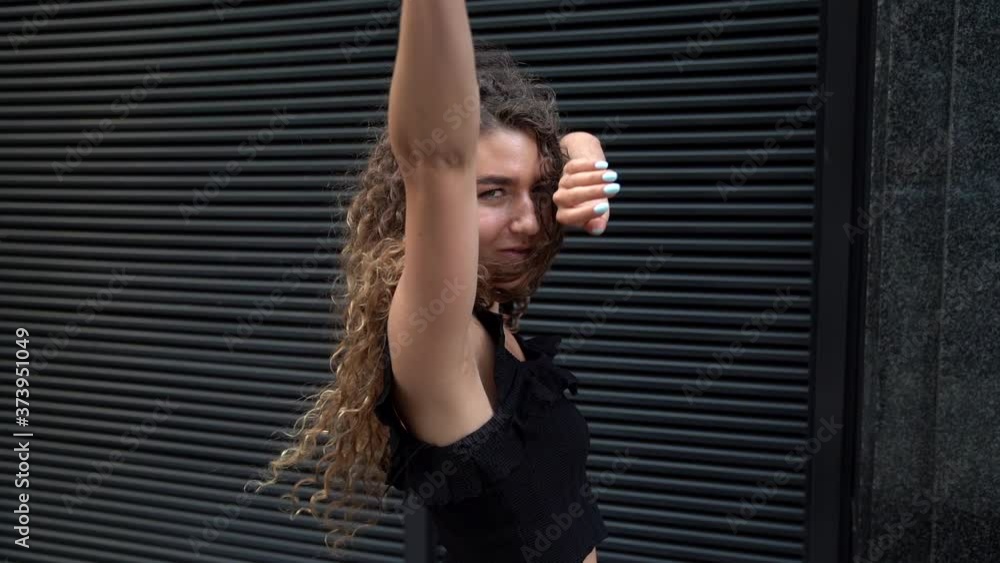 sexual young woman is flirting with camera on street, slender figure and pretty face sexual young woman is flirting with camera on street, slender figure and pretty face