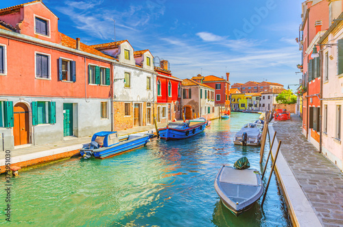 Murano islands with water canal, boats and motor boats, colorful traditional buildings, Venetian Lagoon, Province of Venice, Veneto Region, Northern Italy. Murano postcard cityscape.