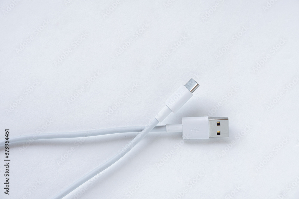 Fototapeta premium White USB Type C charging cable, compatible with many devices, wrapped isolated on white background. 