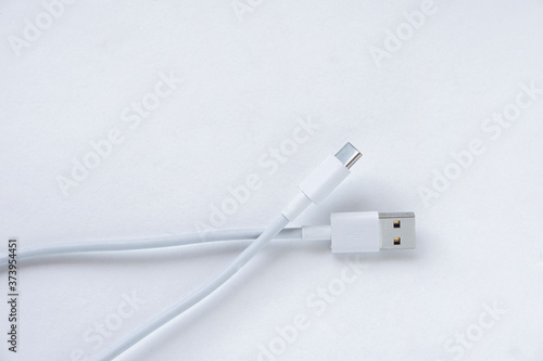 White USB Type C charging cable, compatible with many devices, wrapped isolated on white background. 