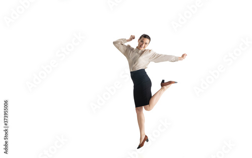 Beautiful business woman, secretary, manager on white studio background. Beautiful caucasian female model in office attire. Copyspace for ad, Concept of business, finance, occupation. Dancing, jumping