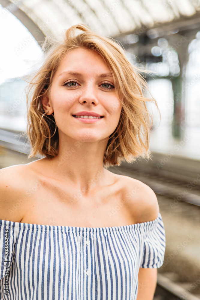 Close-up portrait of a blonde woman on train station