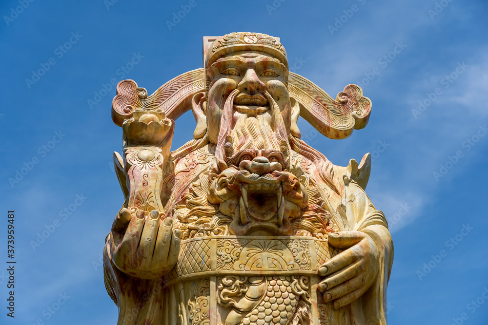 Face of an ancient Chinese warrior statue or god Chinese in a Buddhist temple in the city of Danang, Vietnam