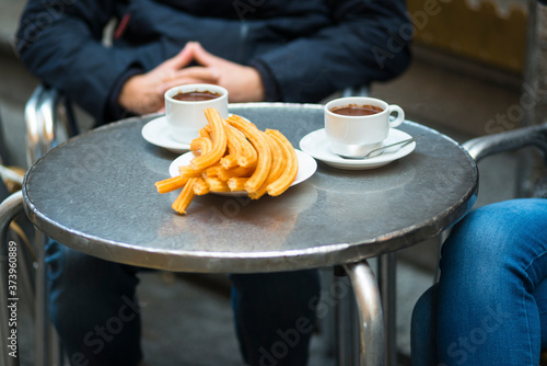 Churros with chocolate in Madrid cafe, Spain.