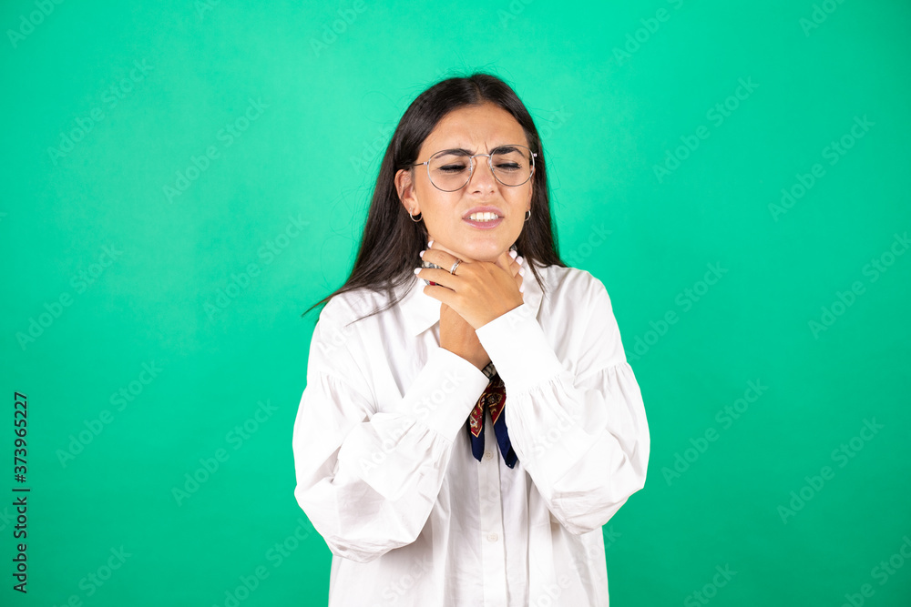 Young beautiful business woman over isolated green background touching painful neck, sore throat for flu, clod and infection Young beautiful business woman over isolated green background touching painful neck, sore throat for flu, clod and infection