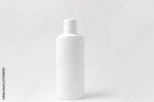 White cosmetic bottle with place to add text on white background