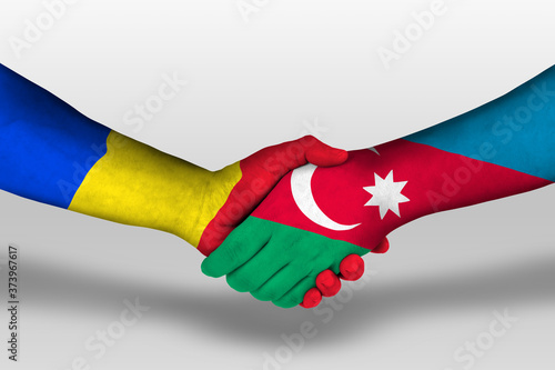 Handshake between azerbaijan and romania flags painted on hands, illustration with clipping path.