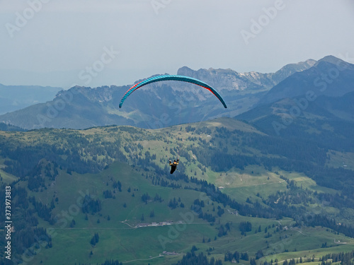 A paraglider takes off in the swiss mountains