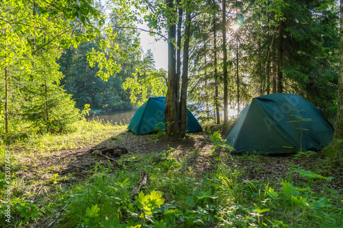 Two tourist tents in a forest glade