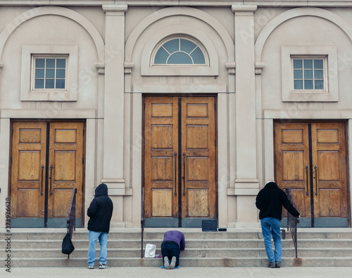 People pray outside of a church during COVID 19 pandemic 