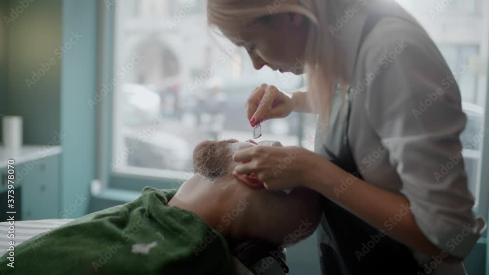 Professional Shaves Thick Beard of a Customer Using Straight Razor. Professional Shaves Thick Beard of a Customer Using Straight Razor.
