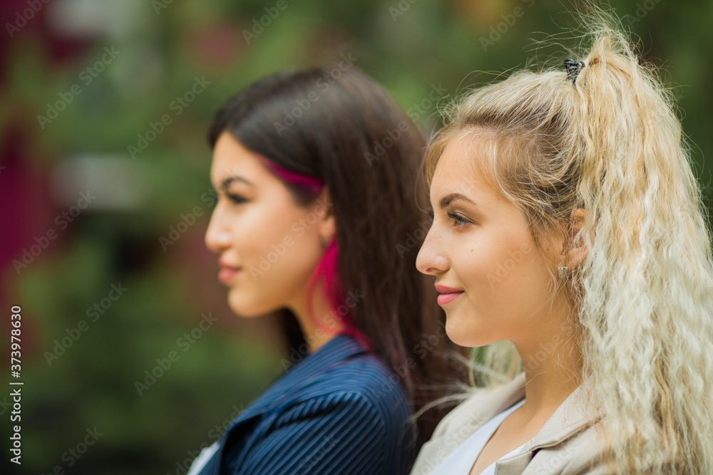 two beautiful young women in suits