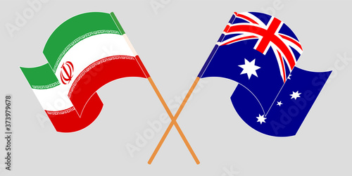 Crossed and waving flags of Iran and Australia