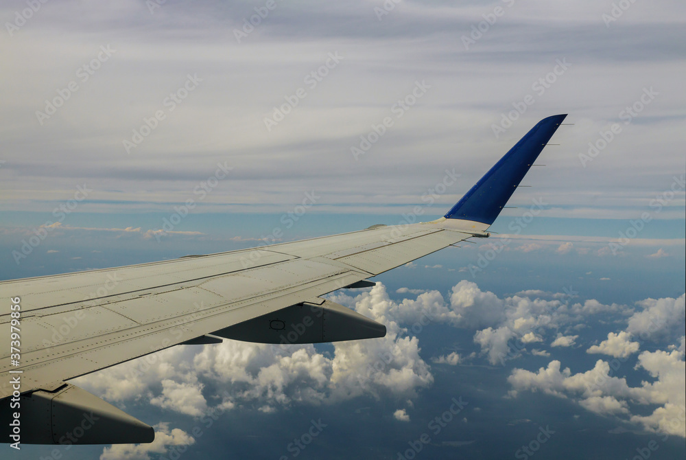 Obraz premium Aerial view of cloud and sky with airplane wing from window