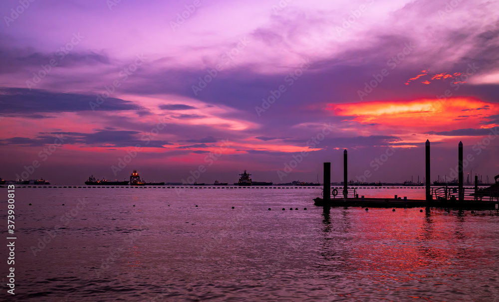 Sunset over the Singapore Strait in Sentosa island