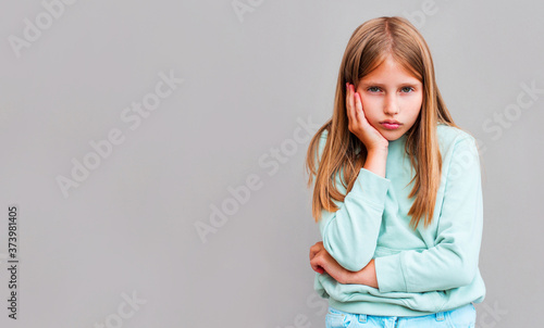 Bright girl bored isolated on gray background