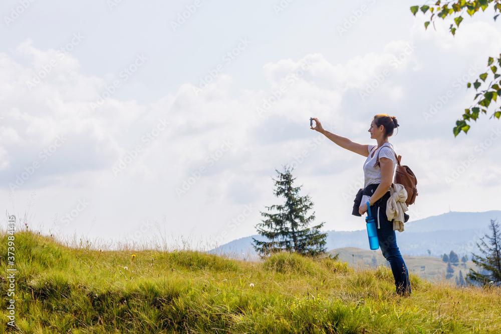 Woman tourist photographs on the phone . Woman tourist photographs on the phone .
