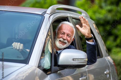 Senior man driving car