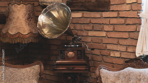 Antique music device vinyl record player old vintage gramophone with horn in elegant retro living room