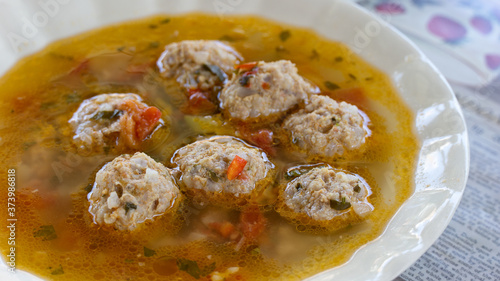 Photos Close up plate with traditional romanian meatballs soup (ciorba de perisoare)