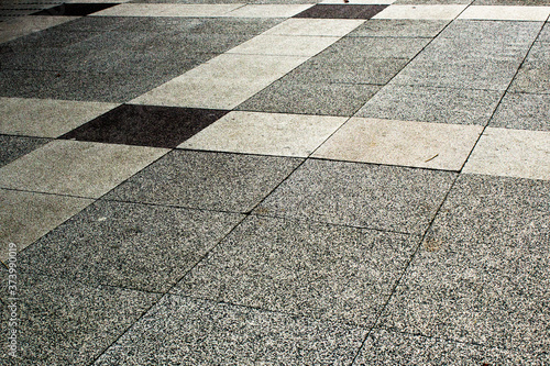 cement floor. black and white pavement texture. cobblestone sidewalk. street architecture