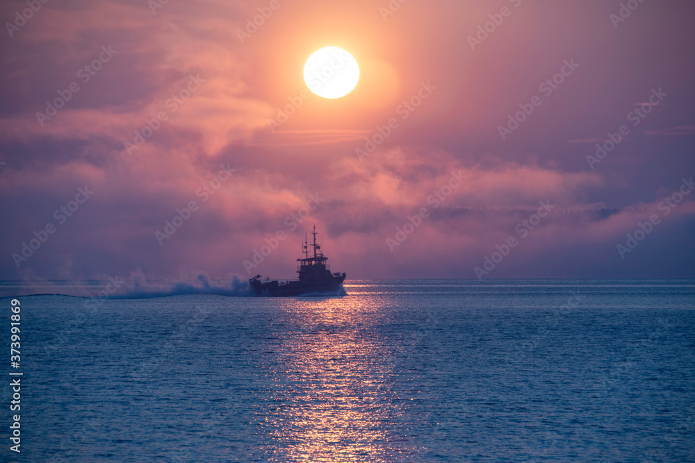 Fishing Boat on the water in a misty morning sunrise