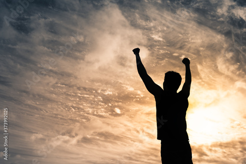 Strong confident man with fist up to the sky. Winning mindset concept. 