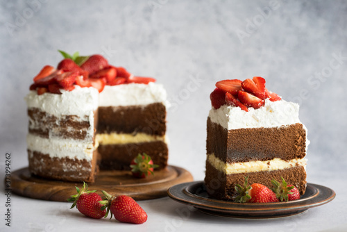 Sliced homemade chocolate naked cake with strawberries.