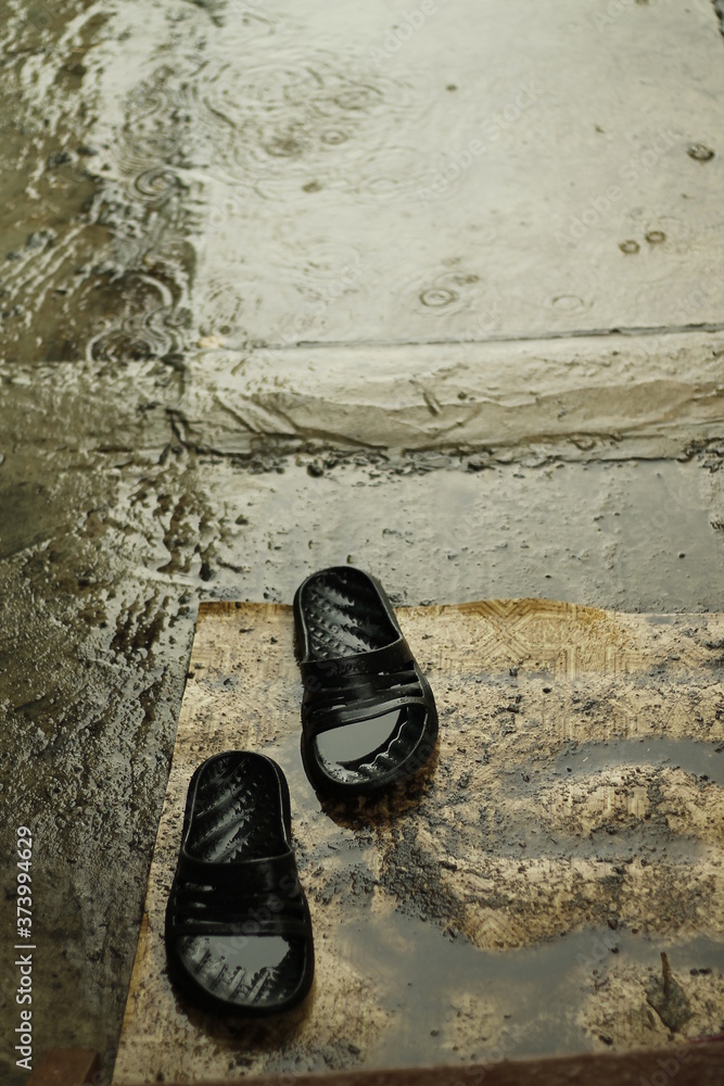 pair of black shoes under rain