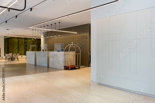 Interior of a hotel lobby with reception desks with transparent covid plexiglass lexan clear sneeze guards