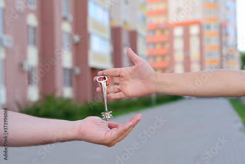 The girl passes the keys to the guy
