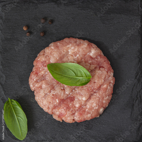 Raw fresh beef burgers or cutlet with pepper photo