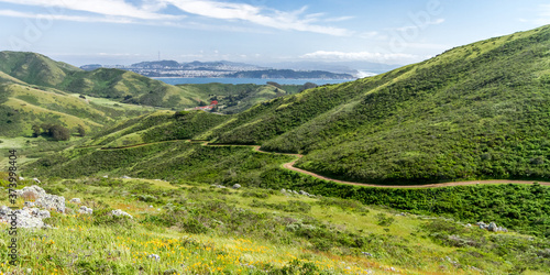 Spring Stroll - The Miwok Trail leads down a valley, with the Golden Gate and San Francisco in the distance. Marin Headlands, California, USA