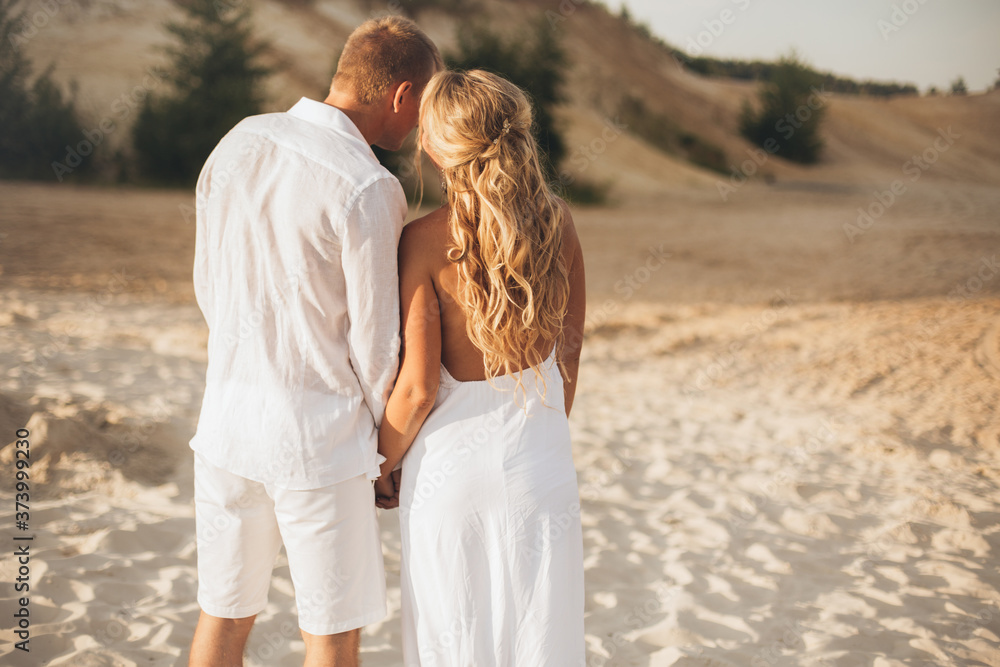 Couple walking on the beach together. Couple walking on the beach together.