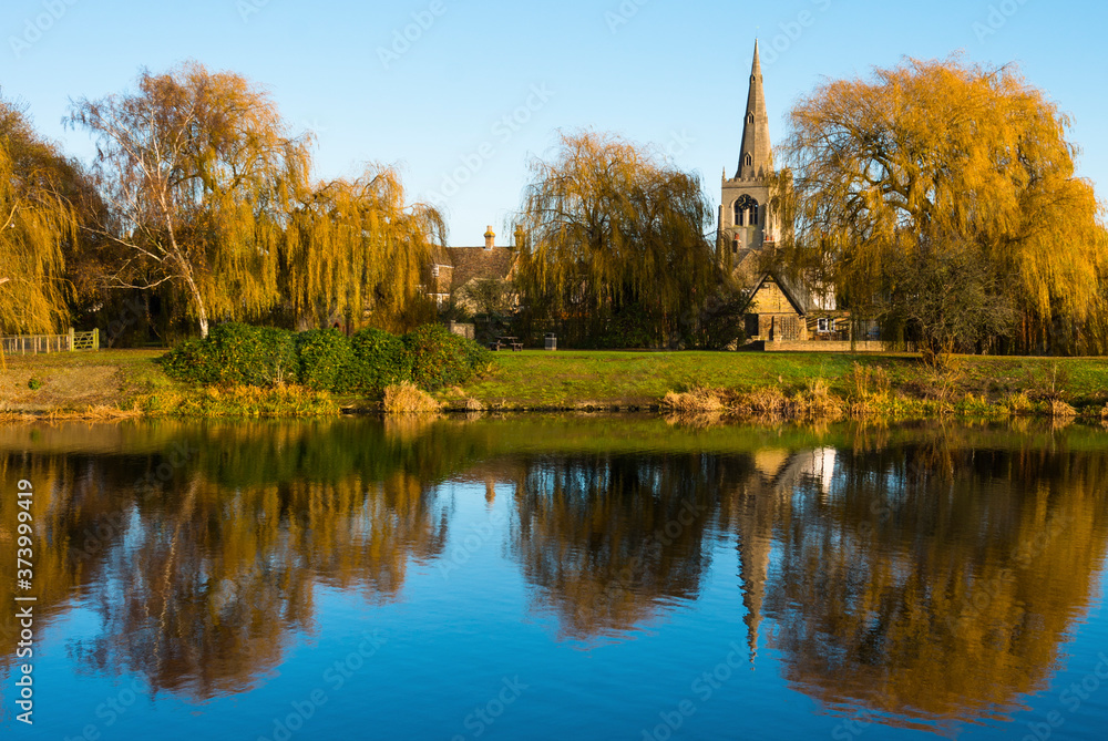 St. Mary the Virgin Church reflected in the lower pool off Great Ouse river, Godmanchester, Cambridgeshire, England, UK