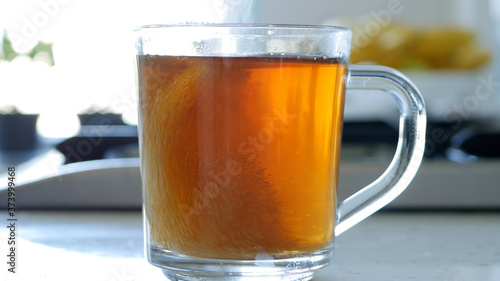 Image with Making a Hot and Aromatic Tea with Sugar and Fresh Lemon Using Natural Tea Leafs