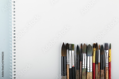 art background with paint brushes top view with copy space