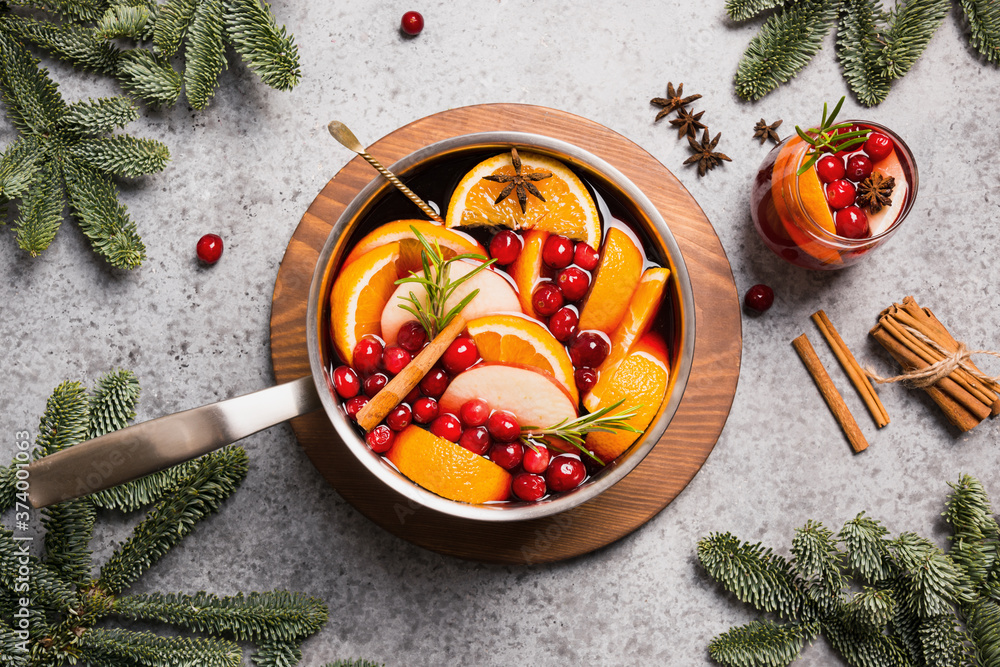 Holiday mulled wine with fruits, apples, orange, rosemary spig. View from above. Christmas traditional beverage. Holiday mulled wine with fruits, apples, orange, rosemary spig. View from above. Christmas traditional beverage.