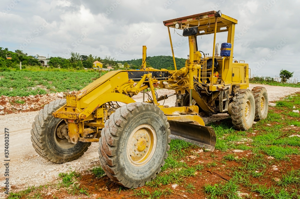 Motor Grader Parked On Road Construction Site