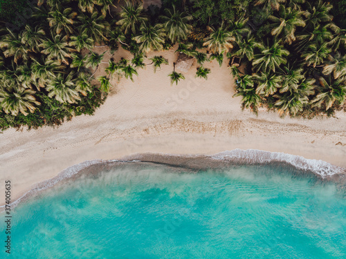 Bild auf Leinwand Aerial drone view of paradise beach with palm trees and blue water at the Esmera