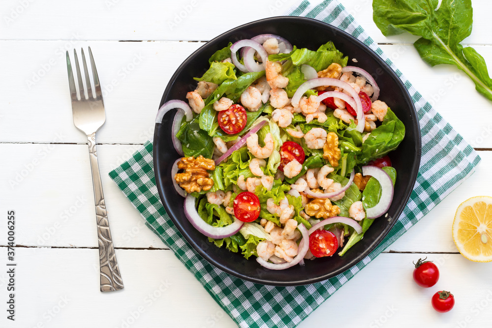 Healthy salad plate. Fresh seafood recipe. Grilled shrimp and fresh vegetable salad. Fried shrimps. Healthy foods. Don't lie flat. Top view Healthy salad plate. Fresh seafood recipe. Grilled shrimp and fresh vegetable salad. Fried shrimps. Healthy foods. Don't lie flat. Top view