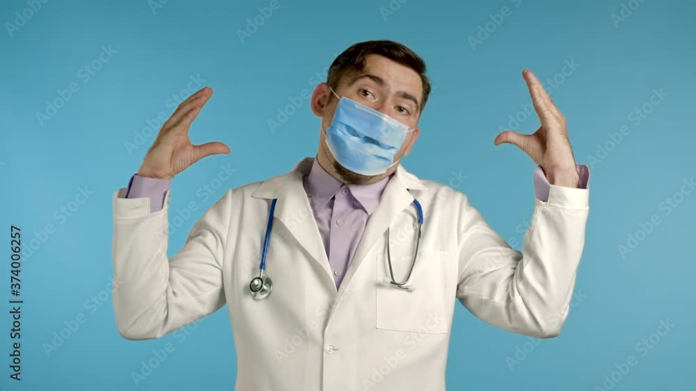 Portrait of funny doctor in medical coat showing bla-bla-bla gesture with hands and mouth isolated on blue background. Empty promises, blah concept. Lier. Portrait of funny doctor in medical coat showing bla-bla-bla gesture with hands and mouth isolated on blue background. Empty promises, blah concept. Lier.