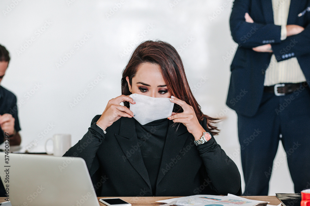 Mexican young woman with face mask at office or workplace in Mexico Mexican young woman with face mask at office or workplace in Mexico