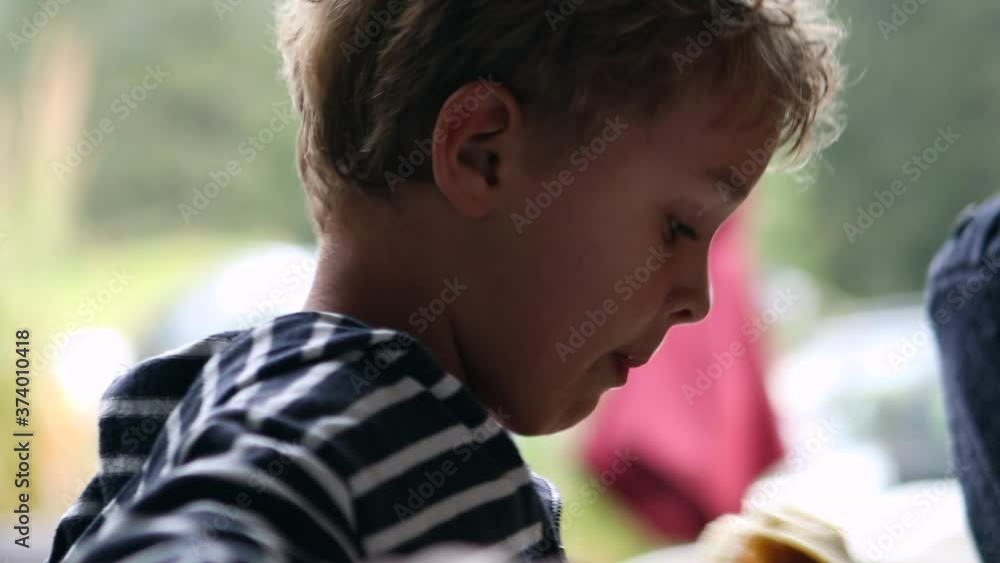 Child eating banana, candid toddler boy eats healthy snack Child eating banana, candid toddler boy eats healthy snack