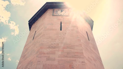 Clock tower in a timelapse in a sunny day.