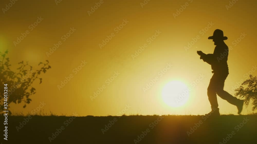 Silhouette of a man sowing the seeds - slo mo Silhouette of a man sowing the seeds - slo mo