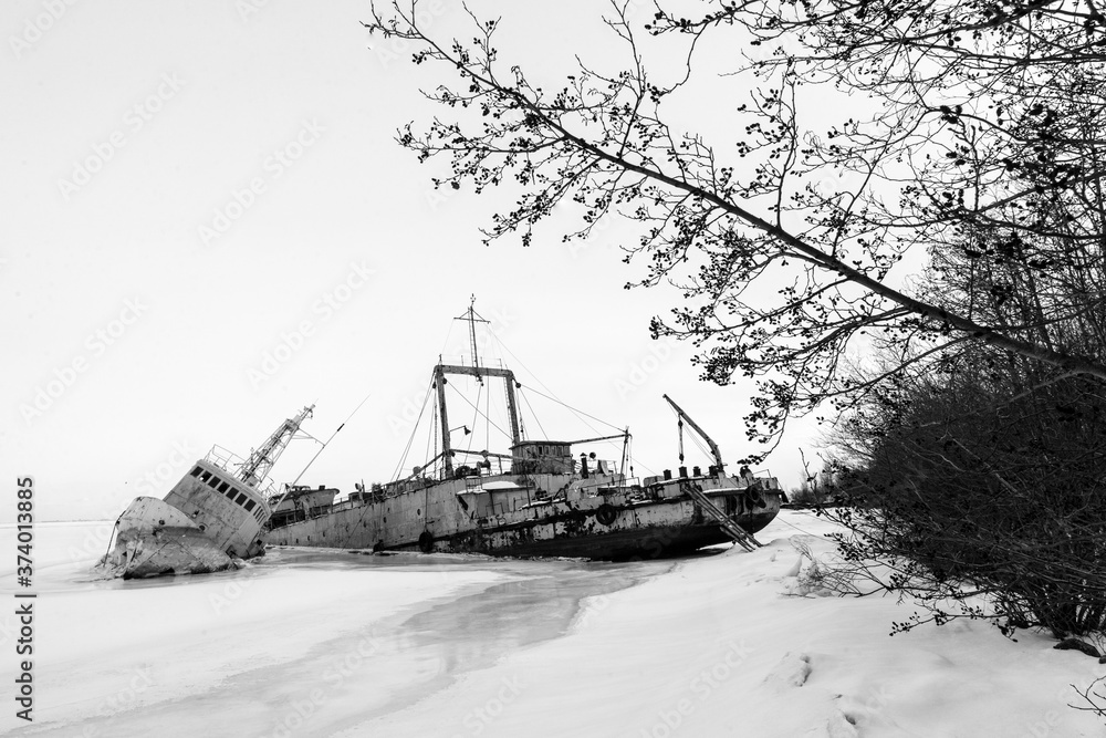 Fototapeta premium Frozen ship graveyard with two rusty industrial ships