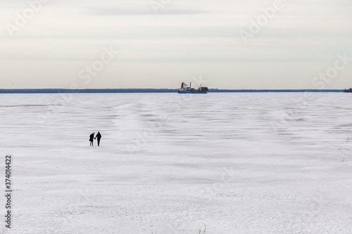 Silhouettes of people in the middle of the icy wasteland of the frozen Gulf of Finland