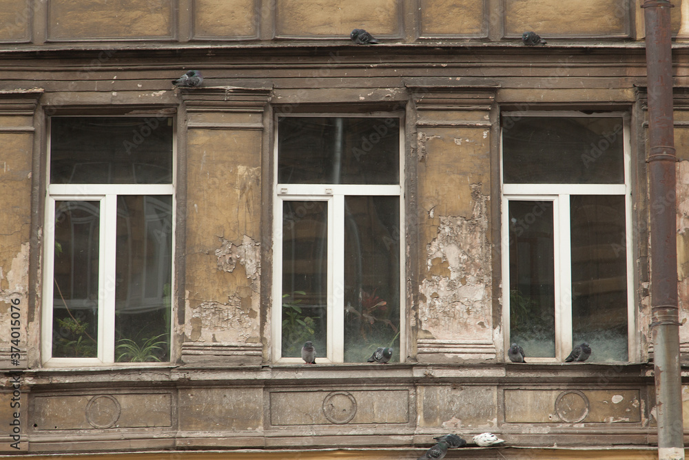 Shabby windows of old apartment buildings in St. Petersburg Shabby windows of old apartment buildings in St. Petersburg